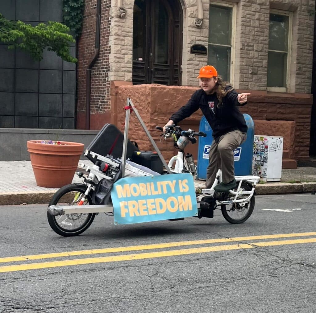 man on cargo bike with mobility is freedom sign